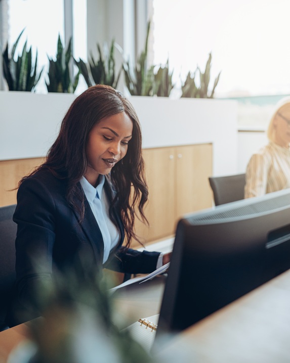 focused young african american businesswoman working at her office desk